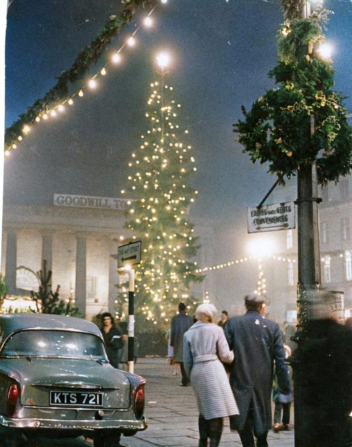 A couple walk arm in arm in the City Square in 1961.