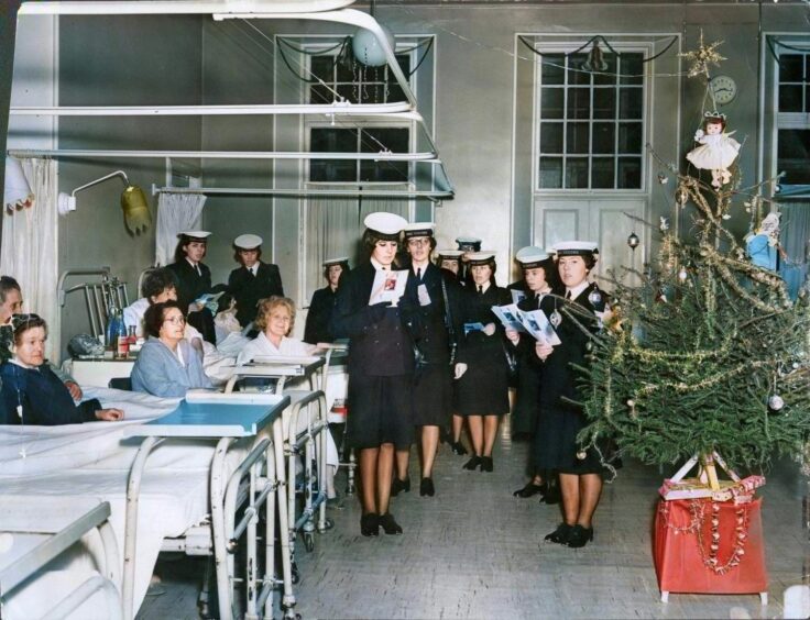 Wrens from HMS Unicorn entertain Maryfield Hospital ward patients in 1965.