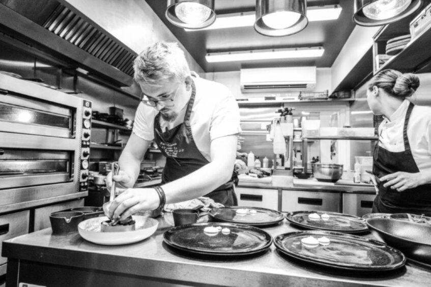 Jack Coghill plating up food in Jack 'O' Bryan's restaurant.