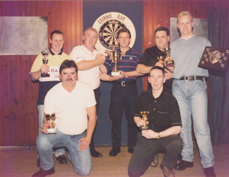 darts players at the Cairnie pose for a picture with their trophies