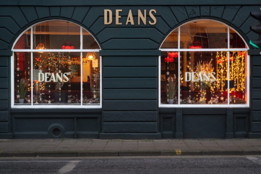 The exterior of Deans restaurant in Perth is a dark blue and there are twinkling fairy lights in the windows - it looks very cosy and festive.