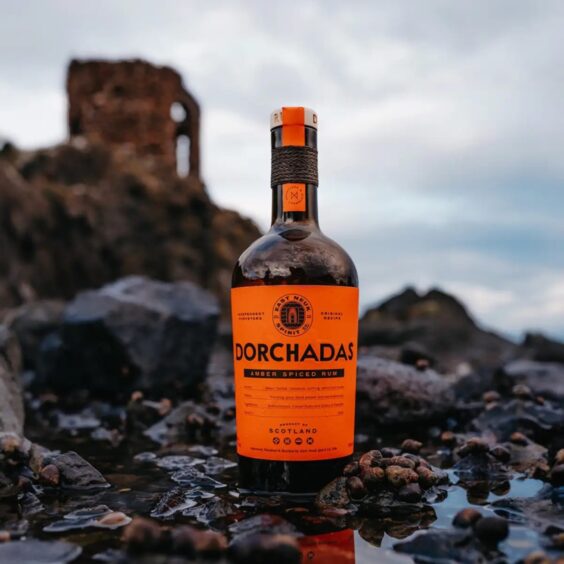 Dorchadas Amber Spiced Rum from East Neuk Spirit Co. on the rocks in front of Lady's Tower at Elie, Fife.