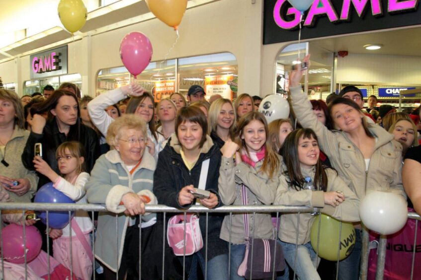 Pictured behind a barrier are some of the fans who welcomed the group to Kirkcaldy. 