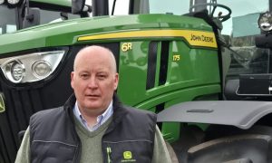 Netherton Tractors general manager Garry Smith alongside John Deere tractor