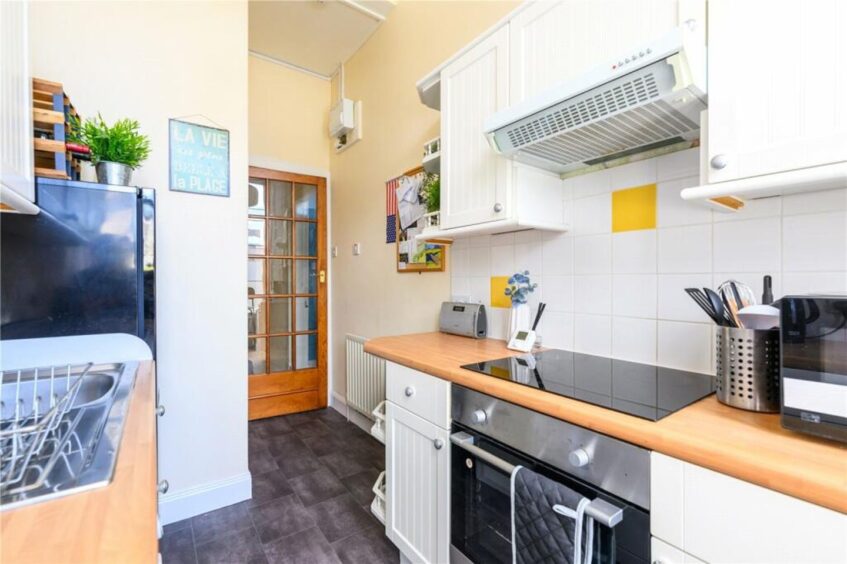 The kitchen has fitted cupboards.