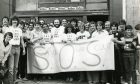 Regulars fighting to save the Scout Bar from closure in 1980 hold up a banner outside the pub.