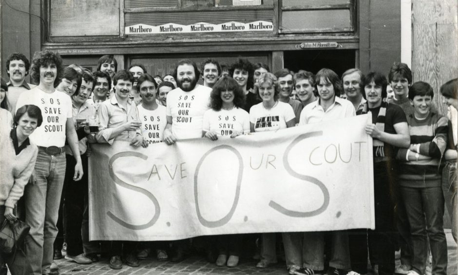 Regulars fighting to save the Scout Bar from closure in 1980 hold up a banner outside the pub.