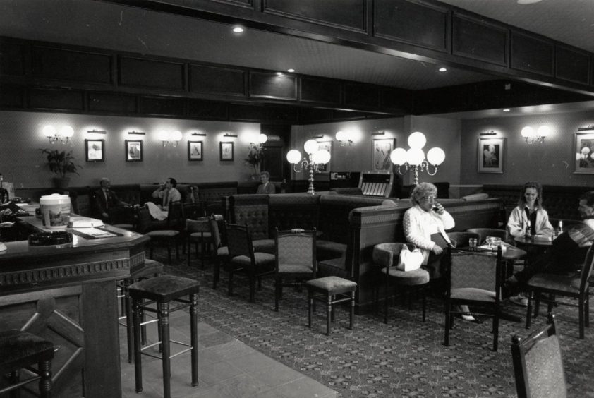 Drinkers sit at booths in The Gaiety Bar in Charleston in May 1991.