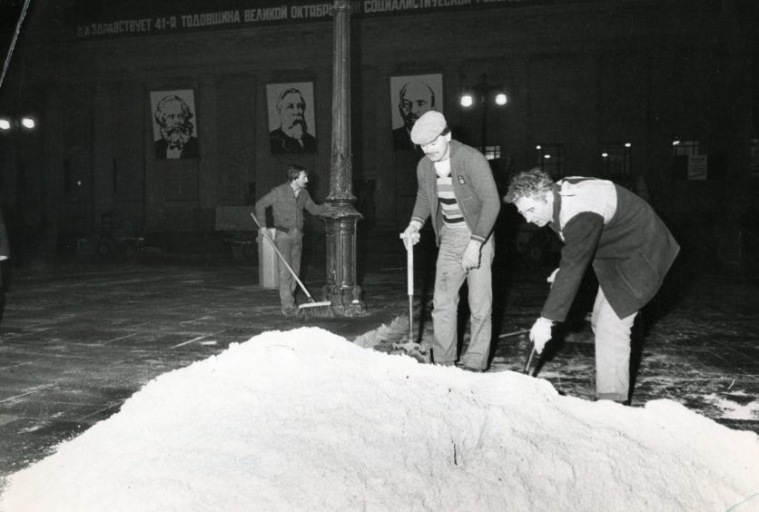 Film crew shovel fake snow in City Square, Dundee, to prepare for filming