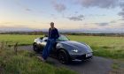 Jack McKeown leans against the updated Mazda MX-5 on a hillside outside St Andrews.