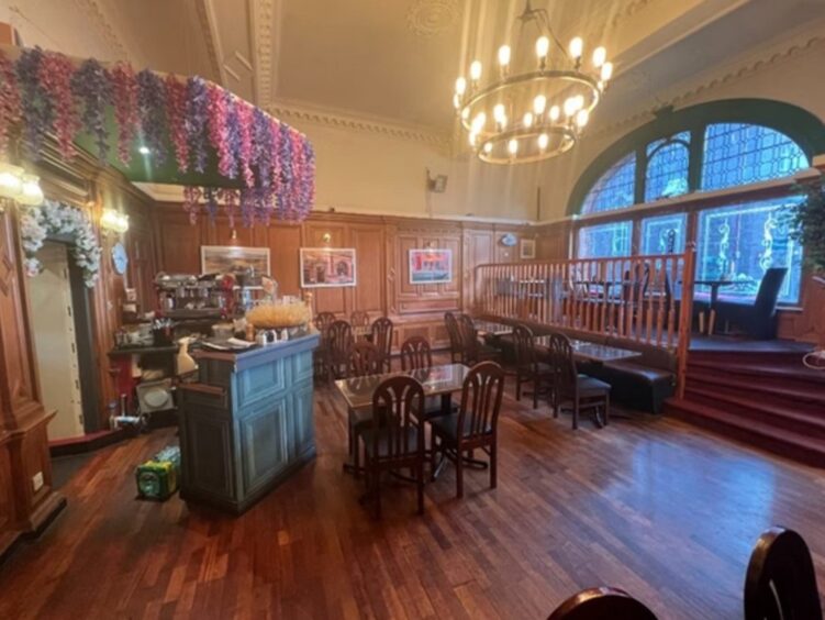 Restaurant features a wooden floor and wood-panelled walls.