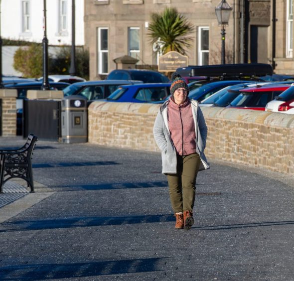 Image shows: Author Helen Moat walking along a street in Broughty Ferry. 