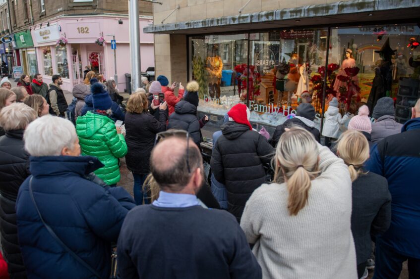 Crowds gather outside the display.