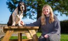 Lucy baker at a picnic table with her dog Berry.