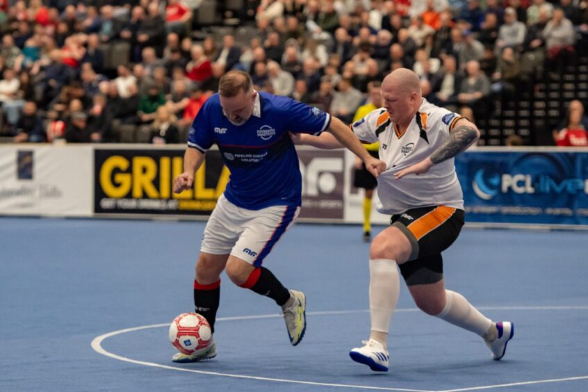 Pantomime villain in Aberdeen, Kris Boyd, struggles to hold off Dundee United's homegrown Scottish Cup winner in 2010, Garry Kenneth