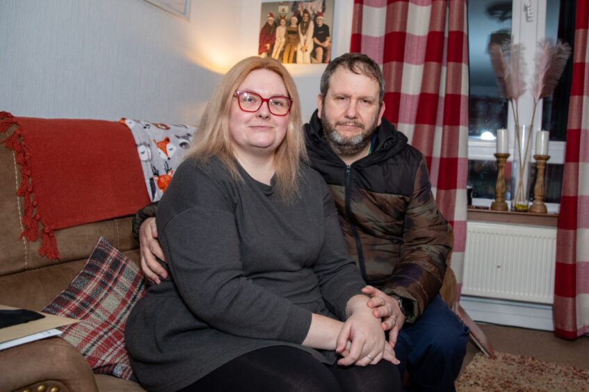 Vicky and Arthur Frater seated on sofa in their home in Almondbank