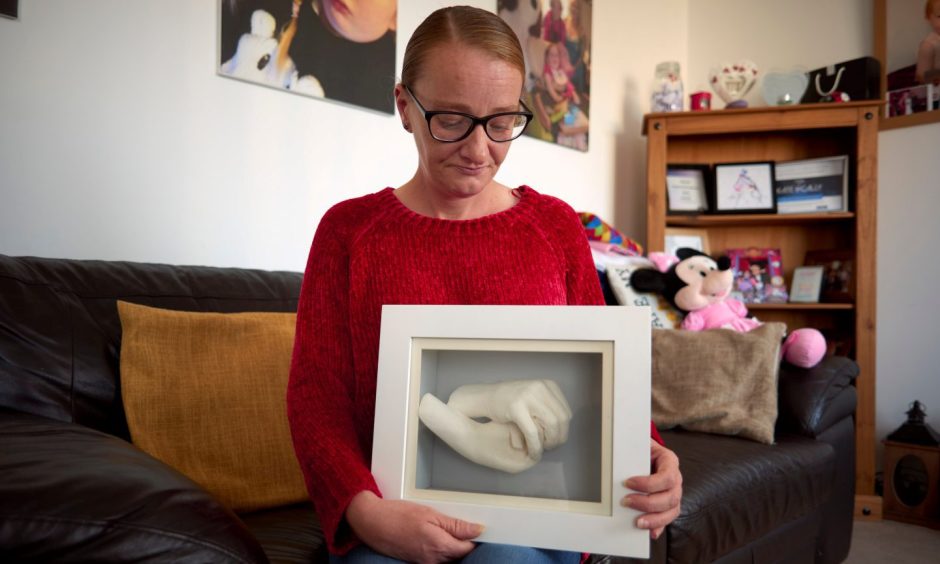 Arbroath mum Kate Miller with the cast CHAS staff helped to make of her and her daughter Cally's hands.