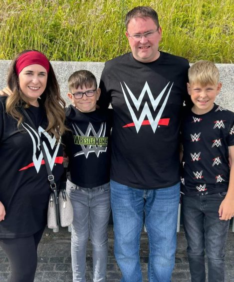 Lynda Simpson, Michael and sons in WWE t-shirts