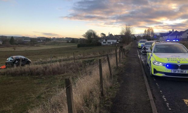 A car ended up in a field following the crash at Muirhead. Image: James Simpson/DC Thomson