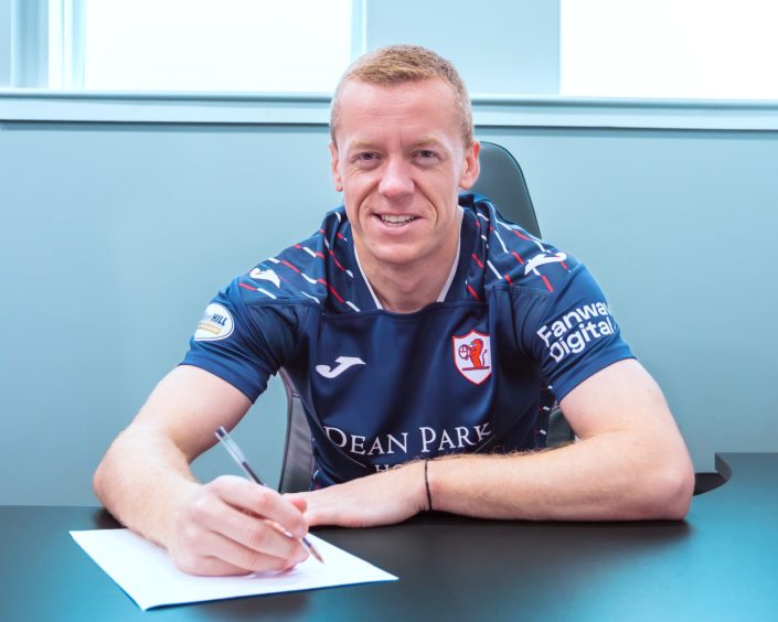 Scott Brown is all smiles as he pens his new Raith Rovers contract. 