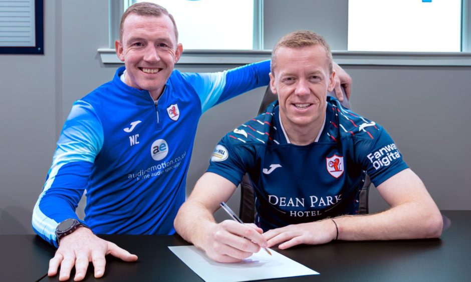 Scott Brown signs his new deal, flanked by Raith Rovers boss Neill Collins.