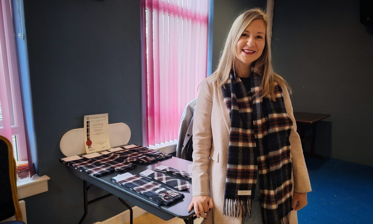 Nicola Delorey-Smith, granddaughter of Thomas Kilpatrick, models a scarf in the new coal mining tartan.