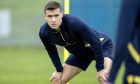 New St Johnstone defender Bozo Mikulic crouches with his hands on his knees during training.