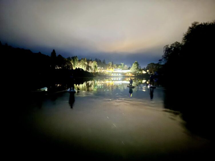 The Green Park Hotel's lights twinkle on the shore of Loch Fascally after dark and are reflected beautifully in the loch.