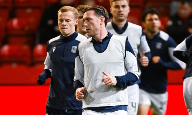 Jordan McGhee warms up with Dundee FC.