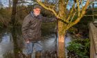 Jack Blair in his flooded Bridge of Earn garden.