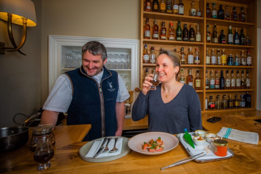 Rachel smiles as she tastes a glass of the forest tea.