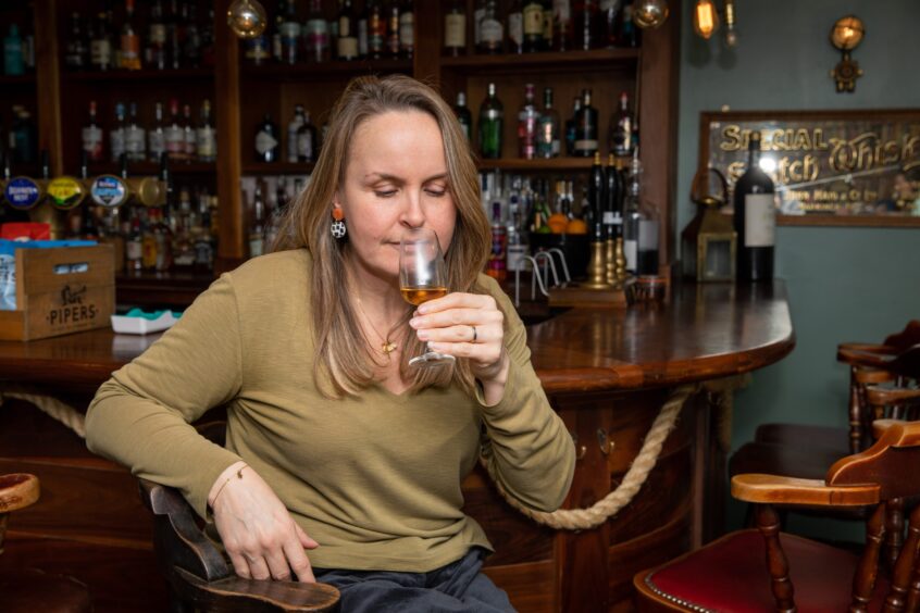 Rachel McConachie nosing a glass of the new single cask rum Dorchadas Washed ashore at the bar in The Ship Inn at Elie.