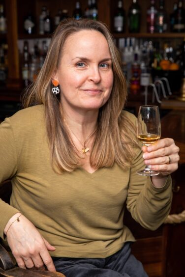 Rachel with a glass of the new single cask rum at The Ship Inn, Elie.