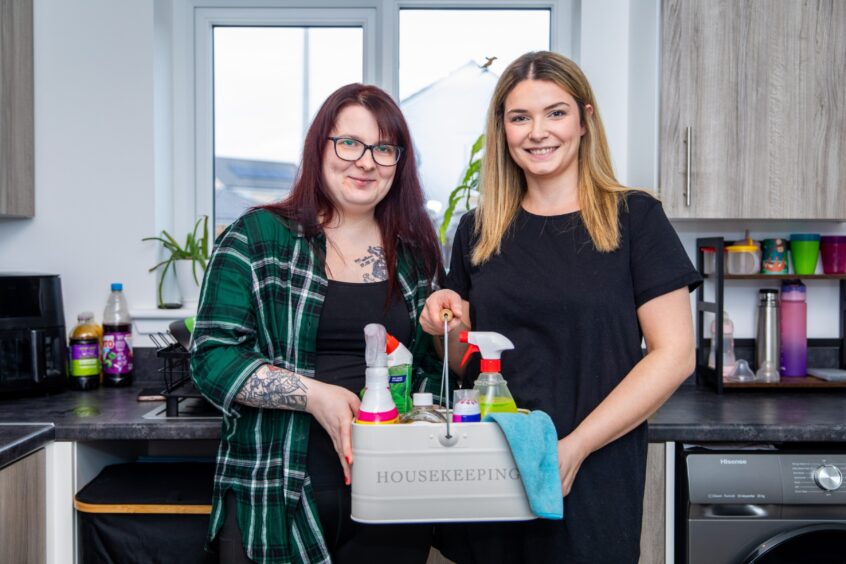 Stephanie Stark (left) and Danielle Hood set up their free cleaning initiative in June.