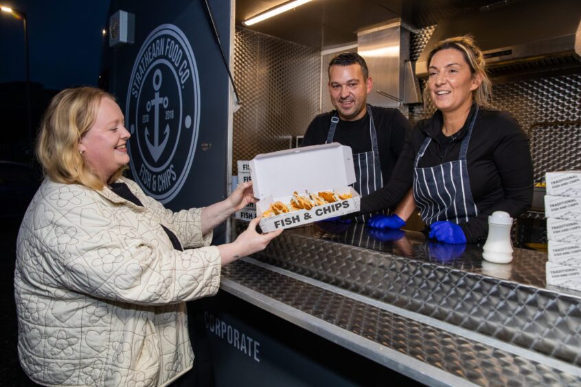 Gee McKenzie-Smith collects her supper from the fish and chips van.