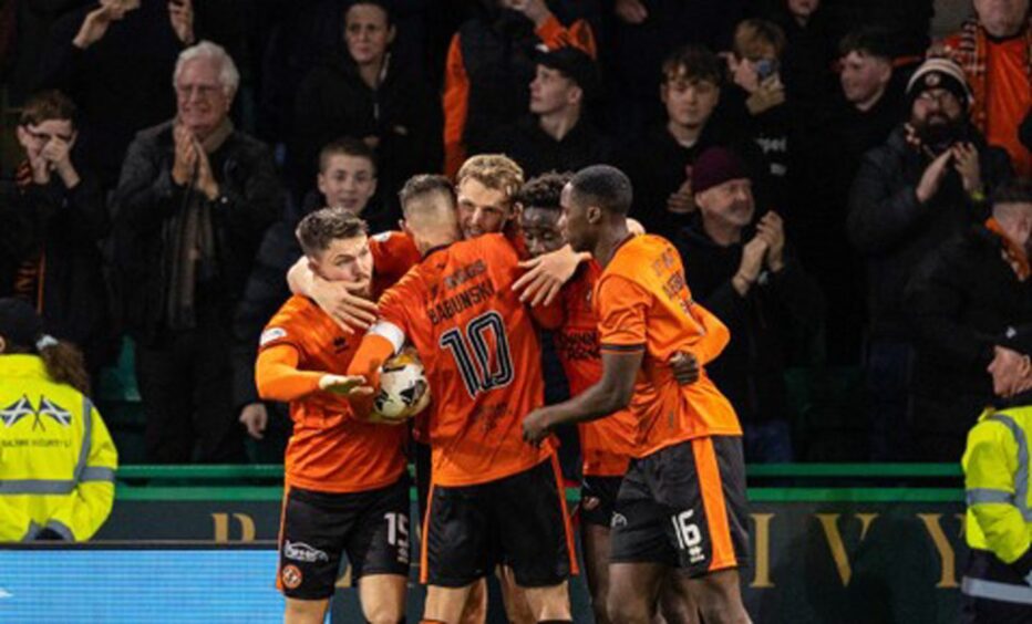 Dundee United's Sam Dalby takes the acclaim of his teammates at Easter Road