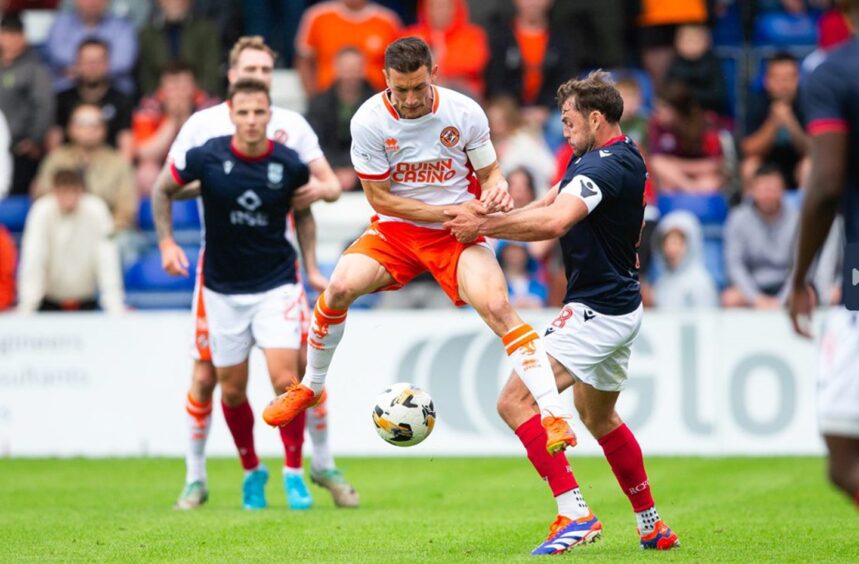 Ross County captain Connor Randall, right, gets stuck in against Dundee United 