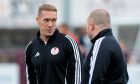 Kelty Hearts boss Michael Tidser on the sidelines in a tracksuit, talking to another coach