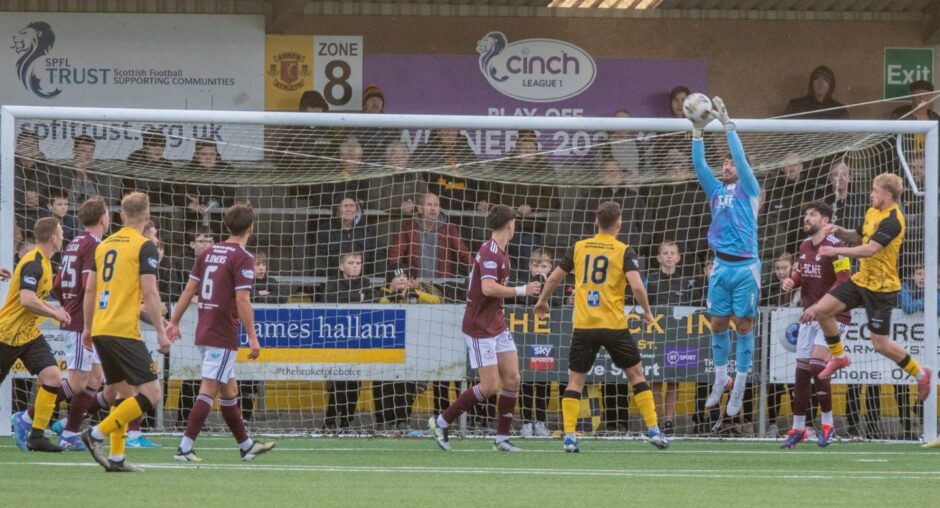 Ruairidh Adams rises high to collect one of several crosses during a decent display of handling