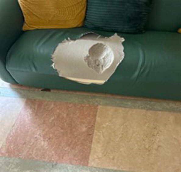 The damaged sofa within the TV Room.