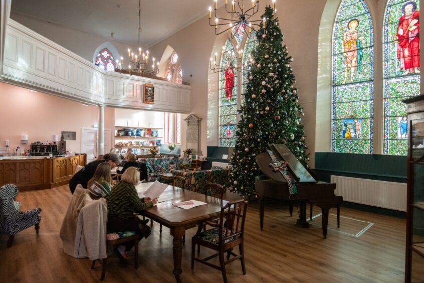 The huge Christmas tree inside The Culdee café had to be so large or else it would've looked silly next to the tall stained-glass windows.