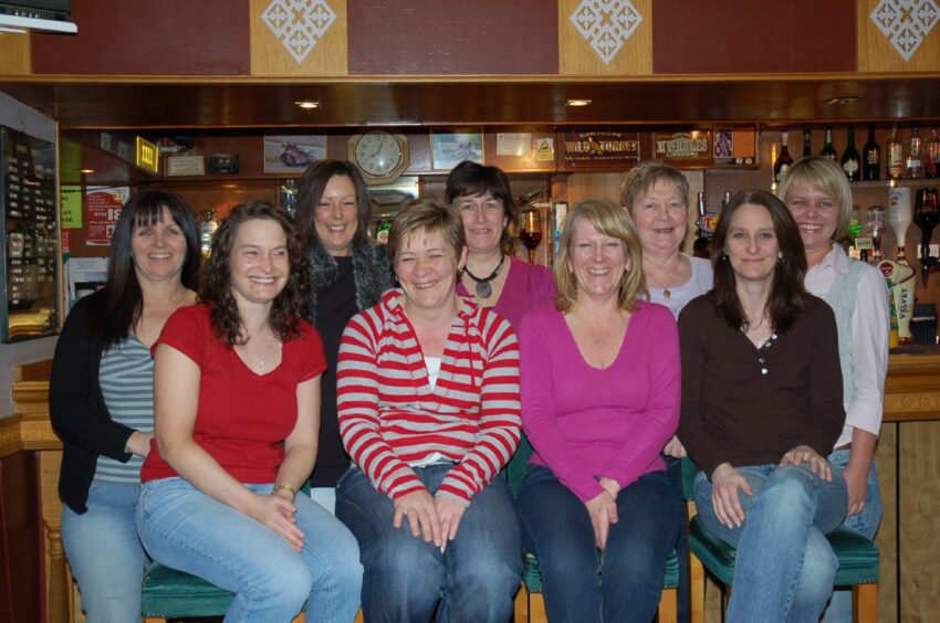 A photograph of the Pageant ladies team at the bar in April 2008.