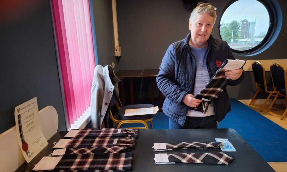 Linda Aitken, from Kinglassie, admires the new coal mining tartan