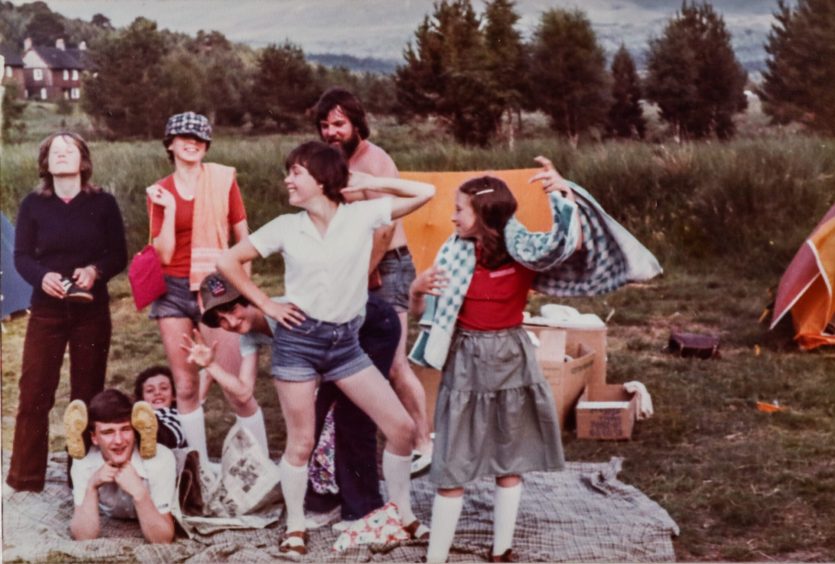 Fintry Clubbie kids strike funny poses as they are pictured outside with a field and trees in the background