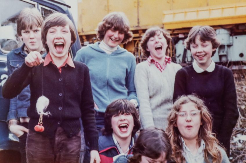 lots of smiling faces as a group of kids poses for a pic outside at Kinloch Rannoch in 1979.