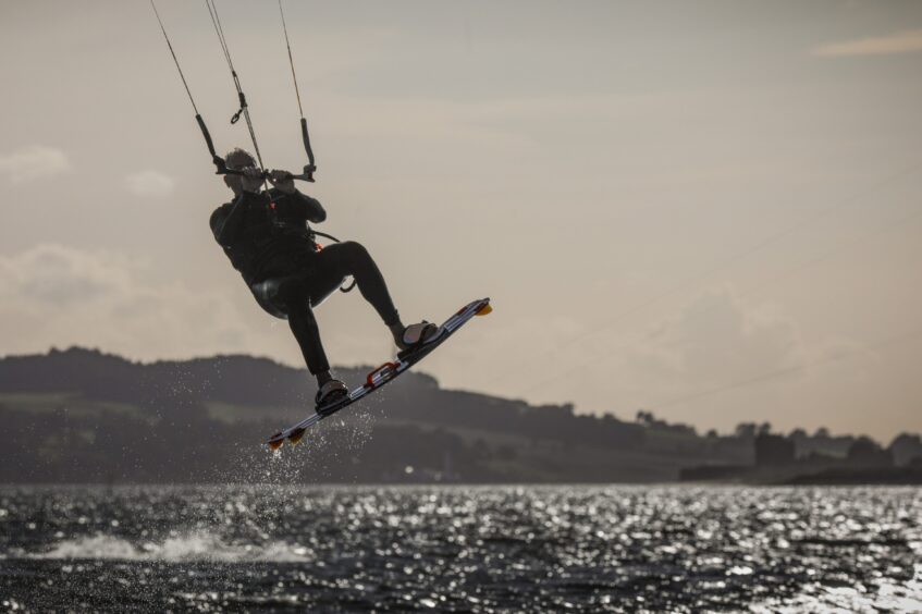 Broughty Ferry kite surfer Paul jumps into the air. Image: Mhairi Edwards.