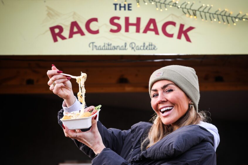 Kate Stretching out the gooey raclette cheese outside The Rac Shack.