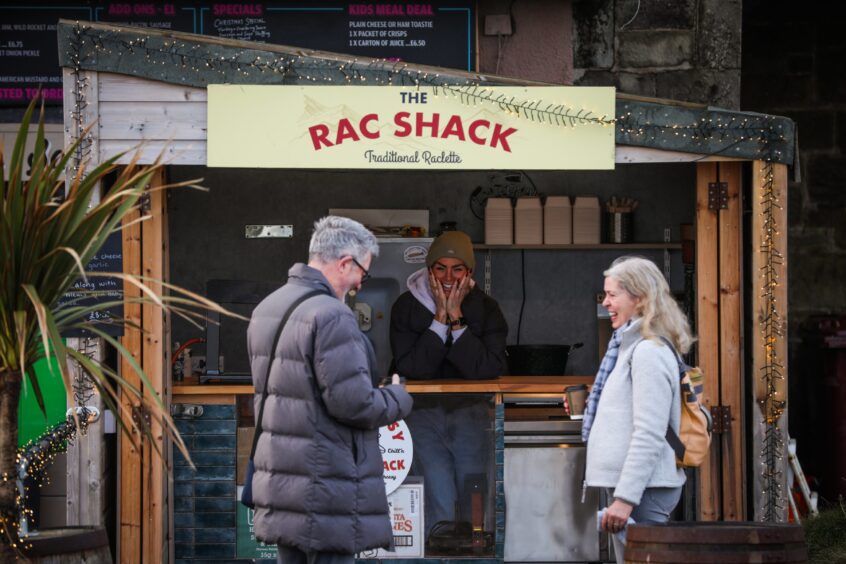 Kate is The Rac Shack with two customers standing outsdie.