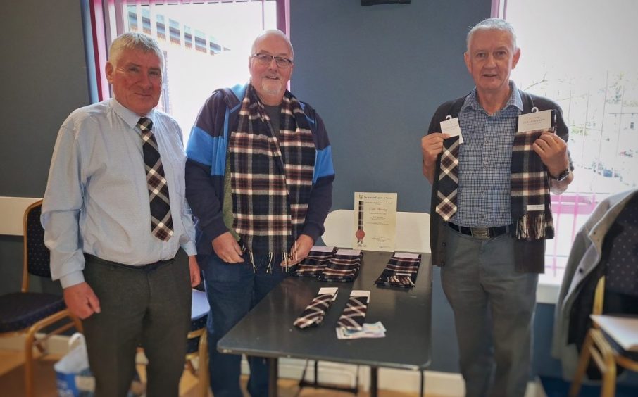 Pat Egan, Iain Chalmers and Tom Adams with items made in the coal mining tartan