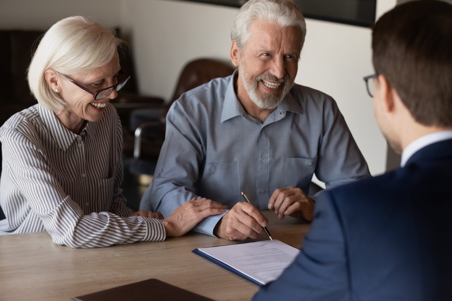 Happy mature couple getting financial advice.